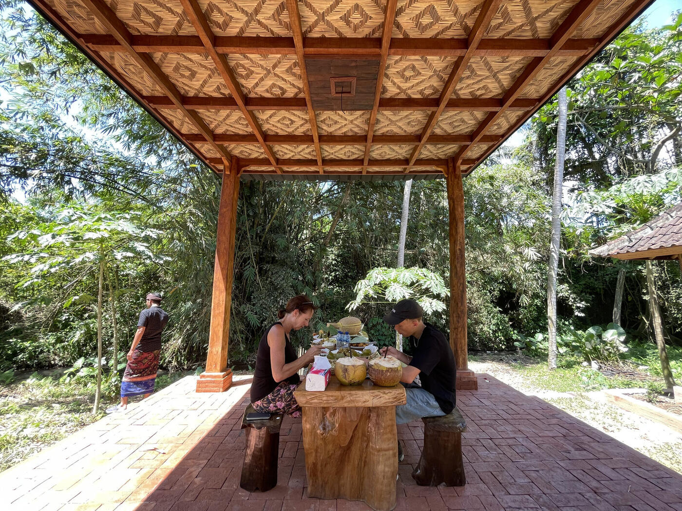 Guests sharing coffee at a Balinese family compound