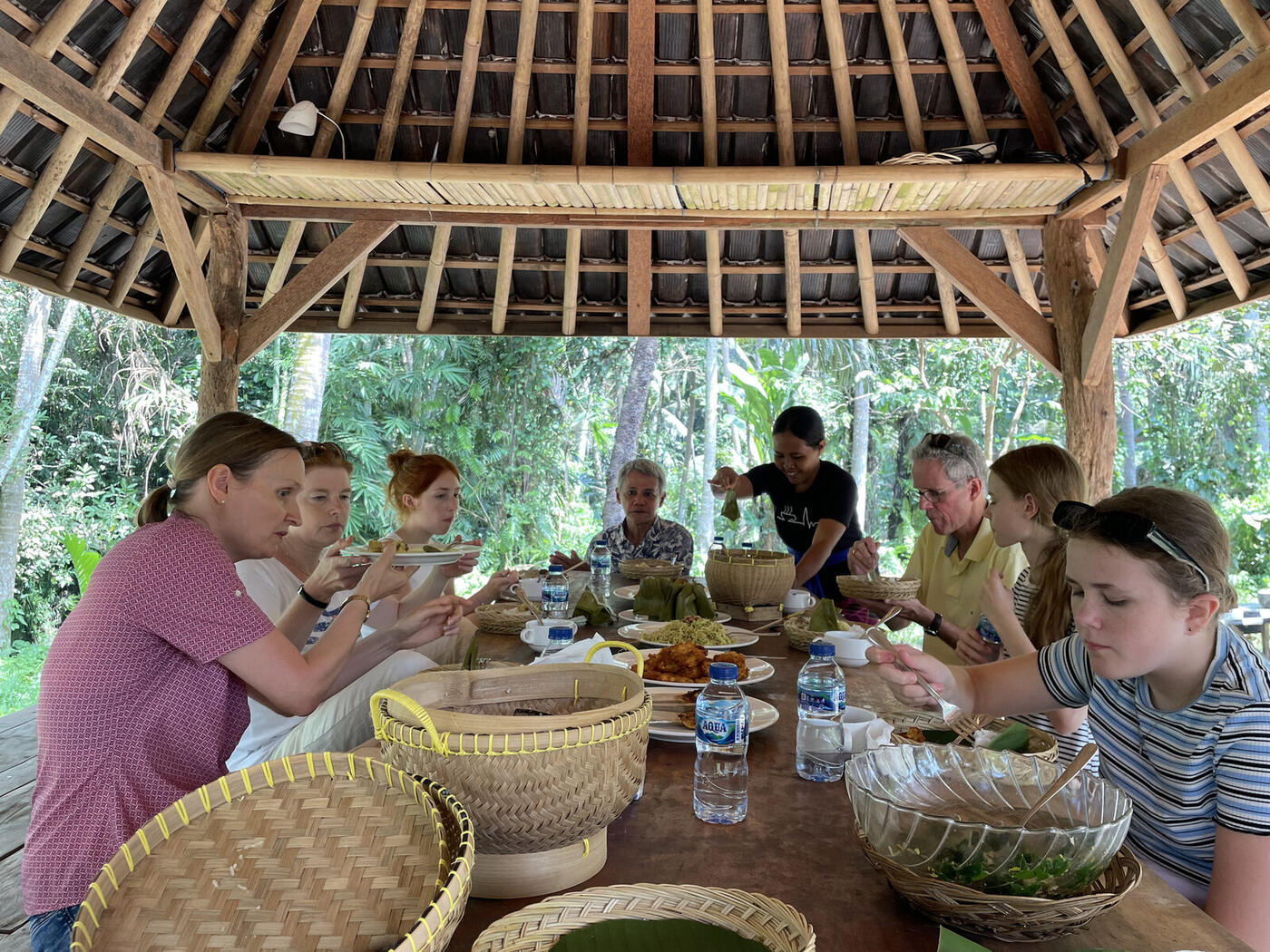 Guests eating lunch under a family compound pavilion